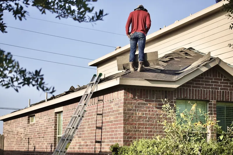 Professional roofer working on a residential roof in Liberty State Park